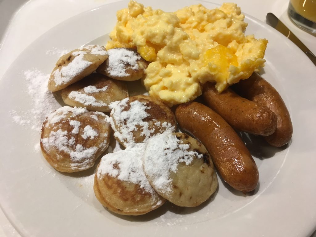 Poffertjes - Small, fluffy pancakes with butter and powdered sugar.